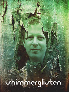 The artist appears behind the peeling bark of a tree, all tinted green.